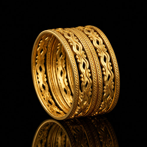 A stack of five ornate gold rings with intricate filigree and floral patterns, displayed on a reflective black surface against a solid black background.