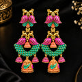 Add a vibrant traditional touch to your jewellery collection with these beautifully detailed multicolor jhumka earrings. Featuring striking pink and turquoise-green accents with intricate gold-tone detailing, the long dangling design creates an elegant statement look.

Perfect for festive occasions, weddings, ethnic outfits, parties and traditional celebrations, these earrings can complement sarees, lehengas, suits and other Indian ethnic wear.