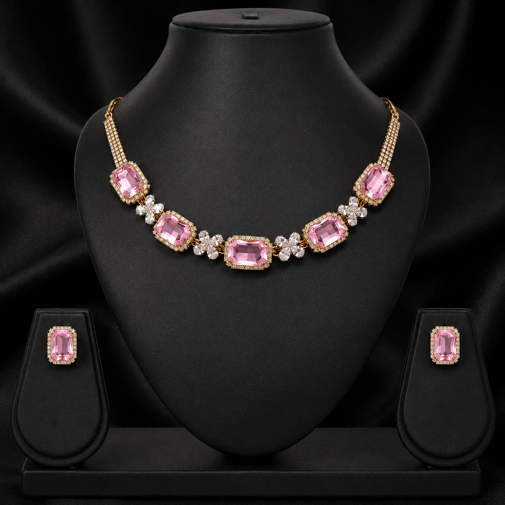 Gold-plated pink gemstone necklace and matching stud earrings displayed on a black jewelry bust against a black satin background.